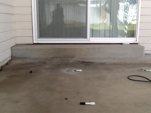 A typical patio with minor settling under the sliding door
