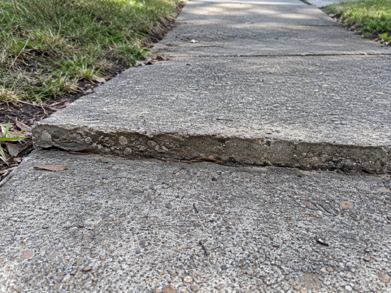Uneven sidewalk before concrete grinding